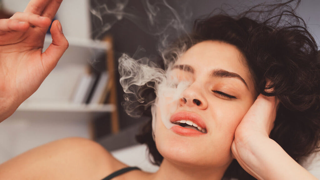 Close-Up of Woman Smoking Weed and Blowing Puffs of Smoke While Having Funny Mood at Home