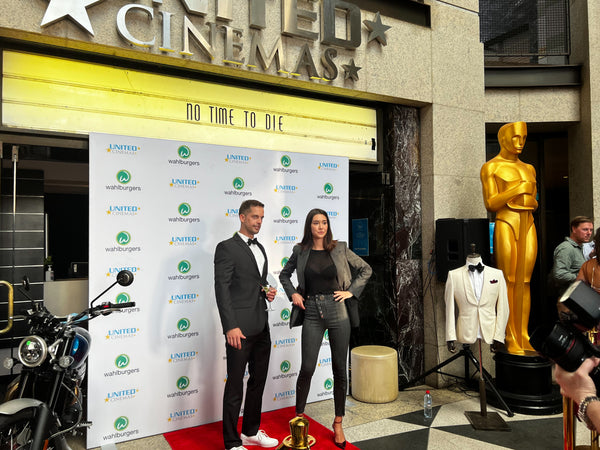 Future Movement’s Luke Bakhuizen and Jennifer Kim pose on the red carpet together at the James Bond premier of No Time to Die 