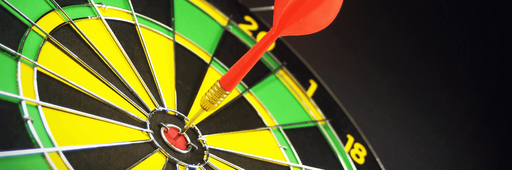 dartboard with dart hitting bullseye