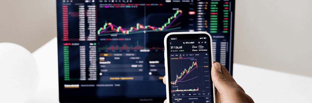 Laptop and mobile showing investment graph