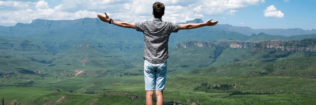 financially free man on top of mountain