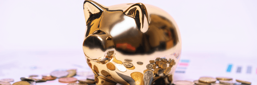 Golden piggy bank surrounded by coins