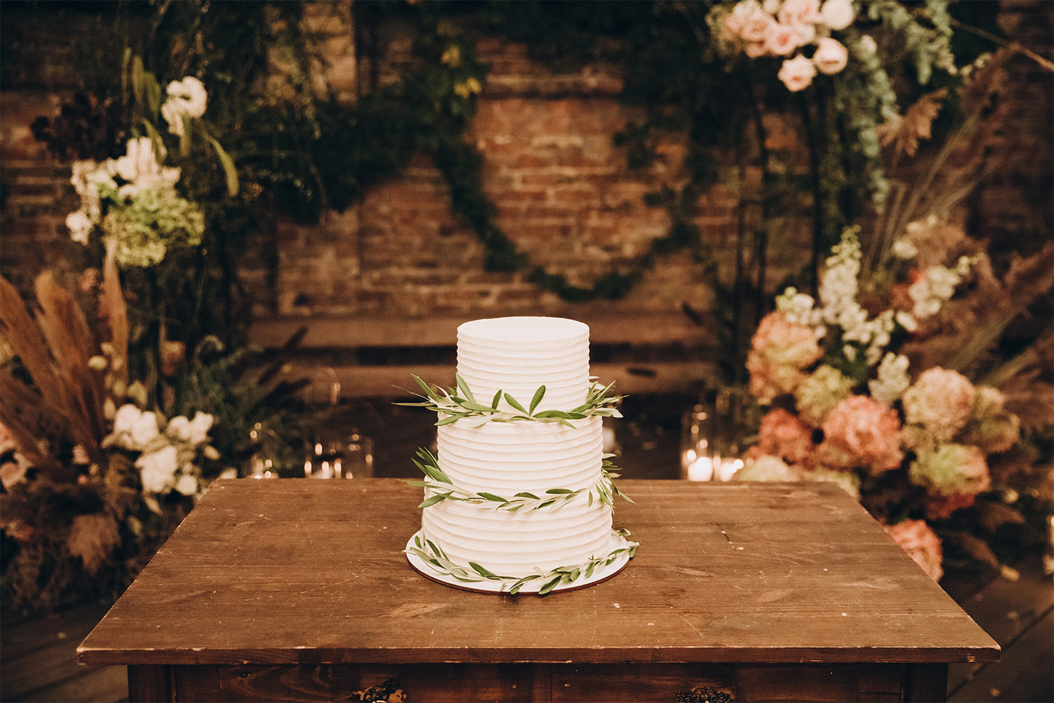 Vegan wedding cake sitting on a wooden table