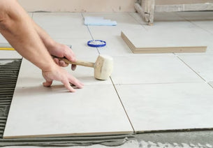 A worker installing tile