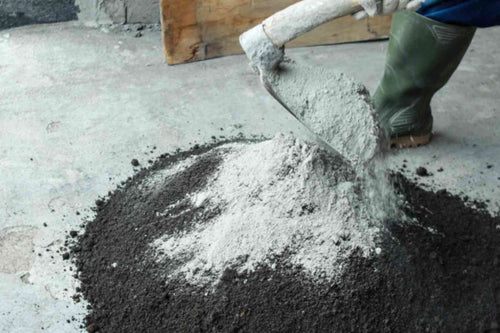  A worker mixing concrete block that's used in building