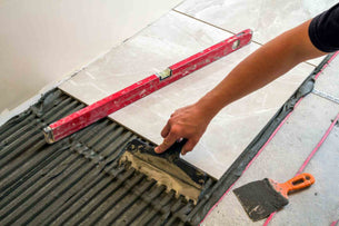 A worker installing tile