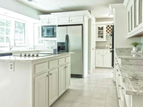  All-white kitchen floor with a kitchen island