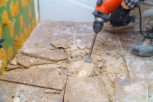 A pro removing a joint tile floor