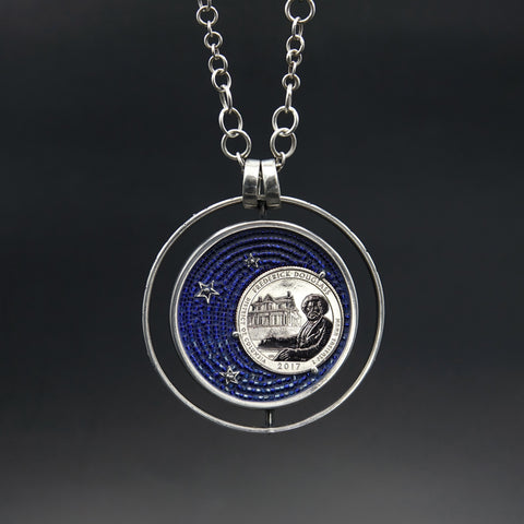 Frederick Douglass commemorative quarter, in a circular pendant with silver stars on a micro-mosaic background in shades of blue.