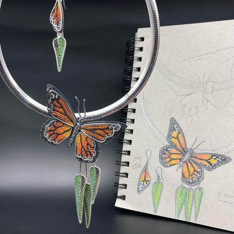 sketchbook with image of monarch butterfly with finished micromosaic pendant and earrings of same.