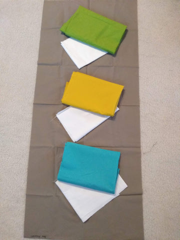 Fabric pull of solids for my sampler quilt. Brown background, blue and cream, mustard yellow and cream, and lime and cream for the blocks.