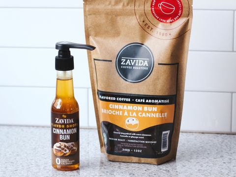 A bag of Cinnamon Bun Coffee and flavored coffee syrup to help make the latte recipe