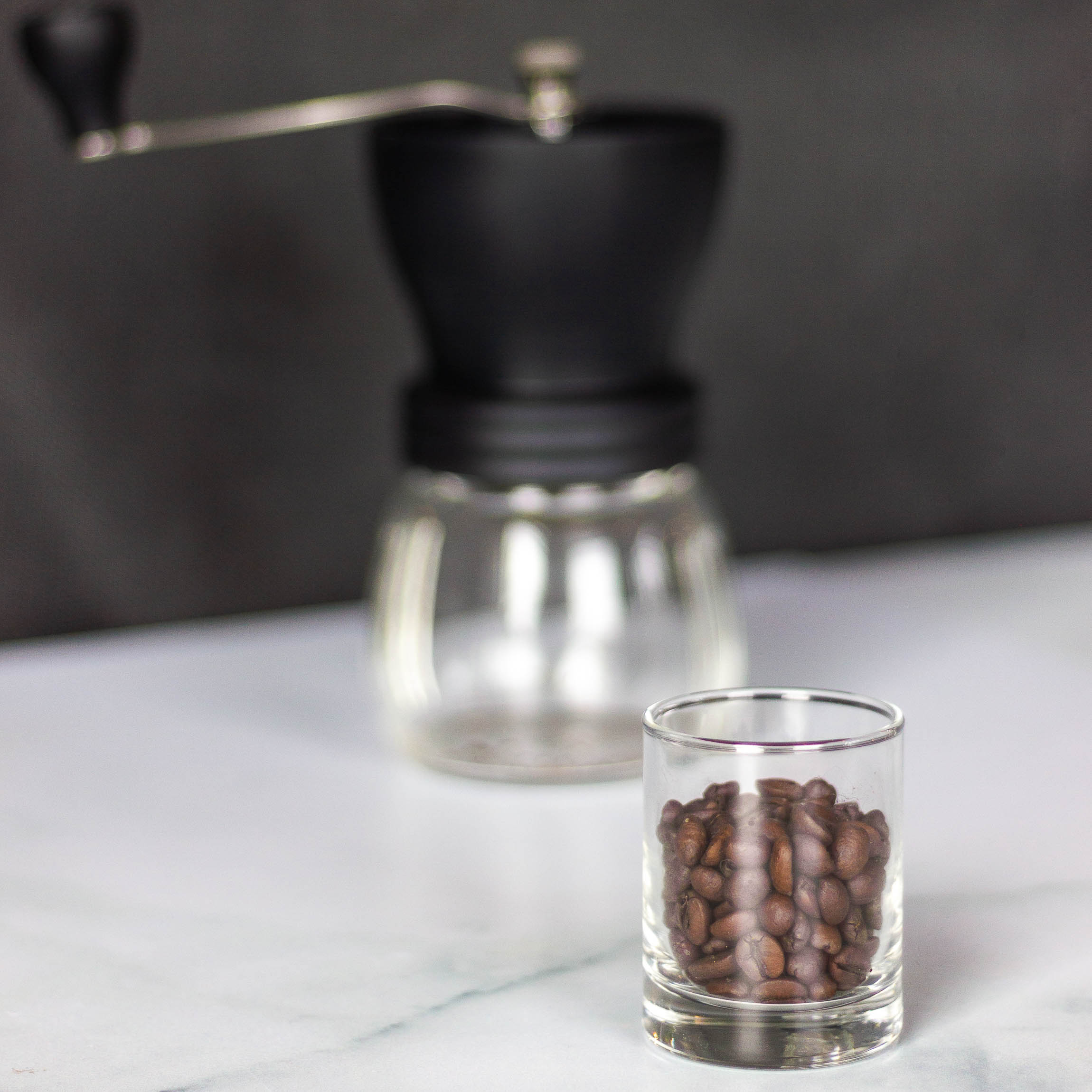 Grind coffee beans with a manual grinder