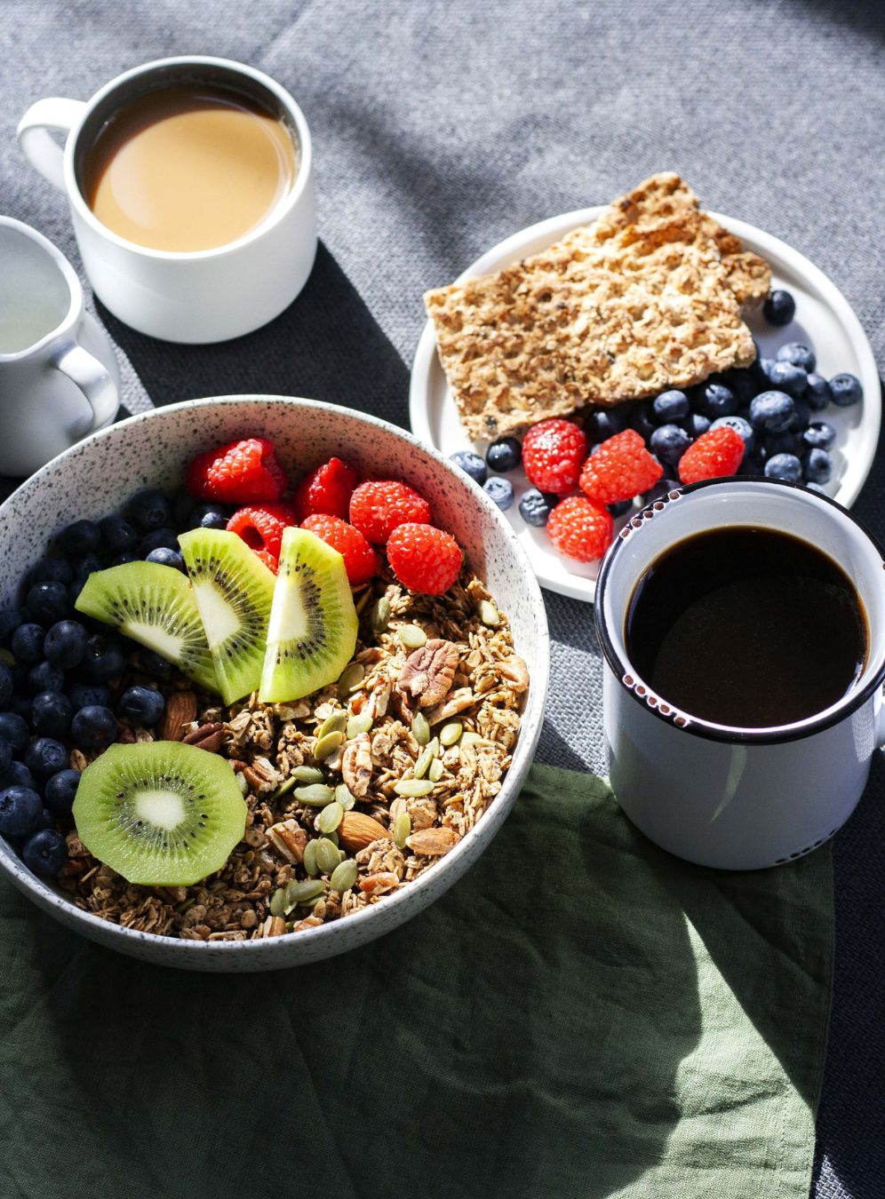 A complete vegan breakfast with grains, nuts fruit, coffee and nut milk