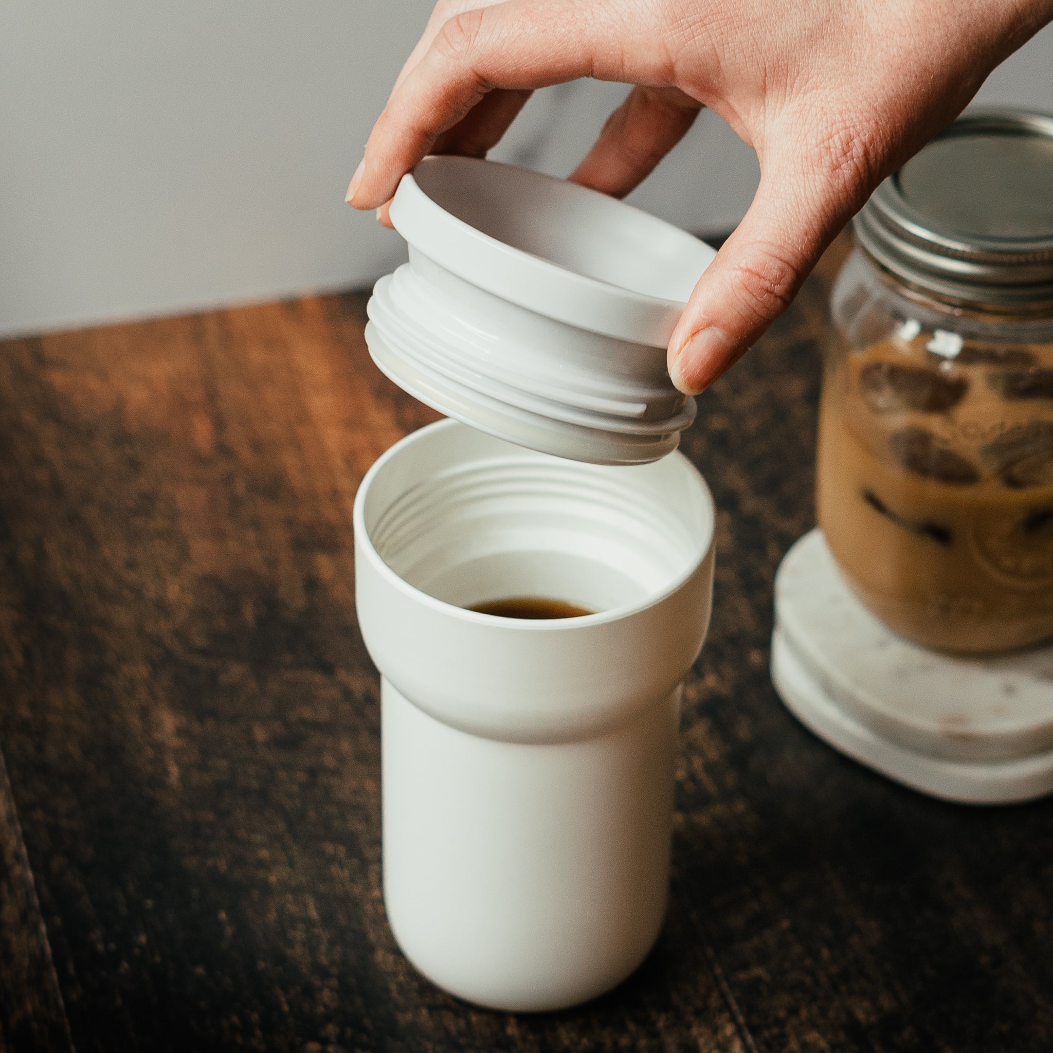 Putting a lid on a travel coffee mug
