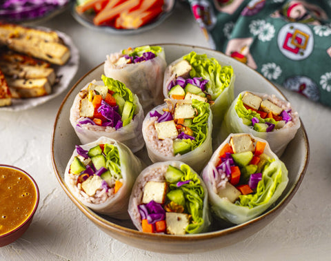 A selection of Tofu Rice Paper rolls with a satay side sauce