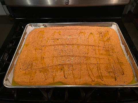 Pour red lentil fermented batter onto pan