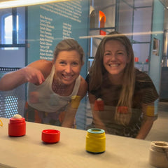 Caroline Farrer & Kelly Riley looking at Solmates Refillable Sunscreen Applicator at Sydney's Powerhouse Museum