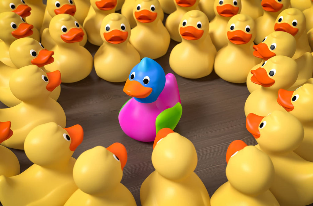 A pink duck toy around hundreds of yellow duck toys