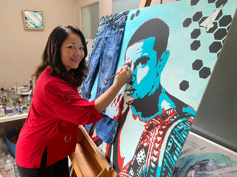 Artist Valerie Khoo painting Tim Cahill's portrait 