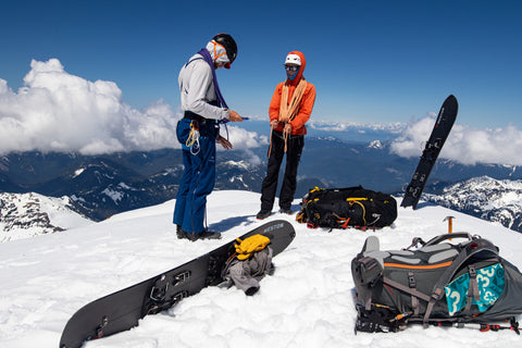 guide and guest tie kiwi coils on Colfax Peak while preparing for a technical splitboard descent