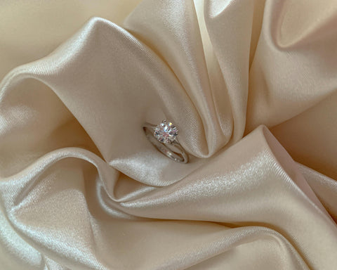 Engagement ring wrapped in Beige Fabric