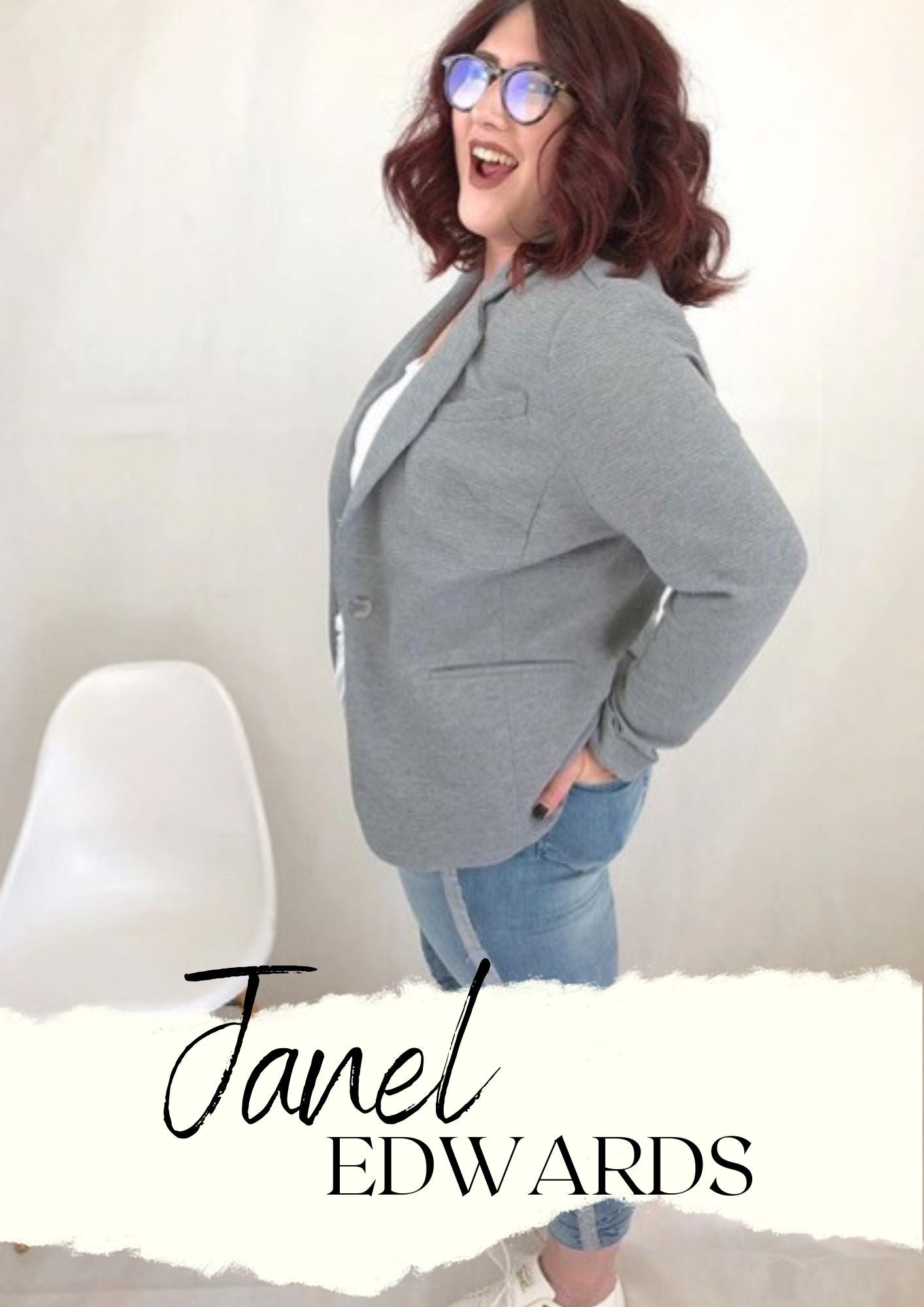 Janel Edwards - Woman with glasses in a suit and jeans.  Hands are in the back pockets.