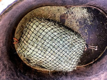 slow feed hay net clipped inside tub