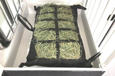 Horse trailer manger hay bag secured in straight load horse trailer manger