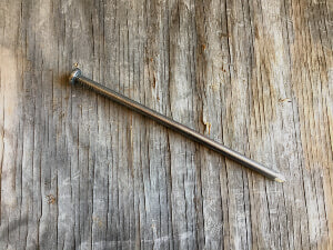 Nail spikes to secure tarps on hay barn hack