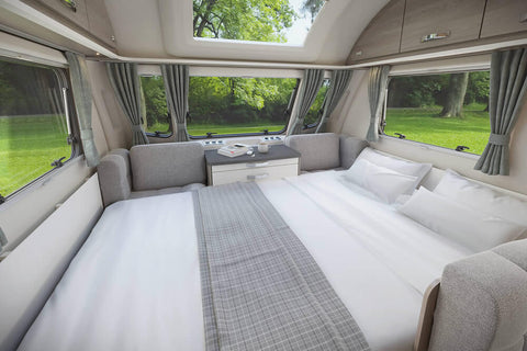 Swift Caravan Dinette Area with a Made-up Mattress Topper