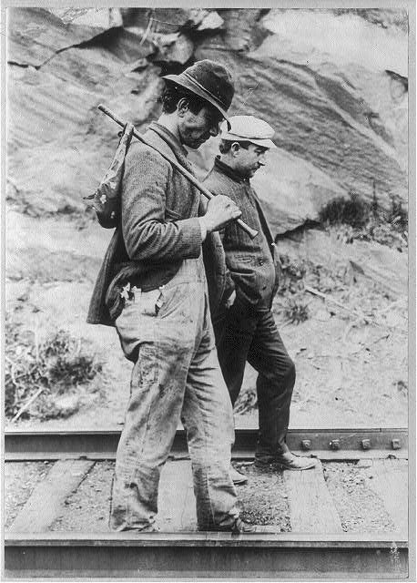 Picture of two men walking on railroad tracks