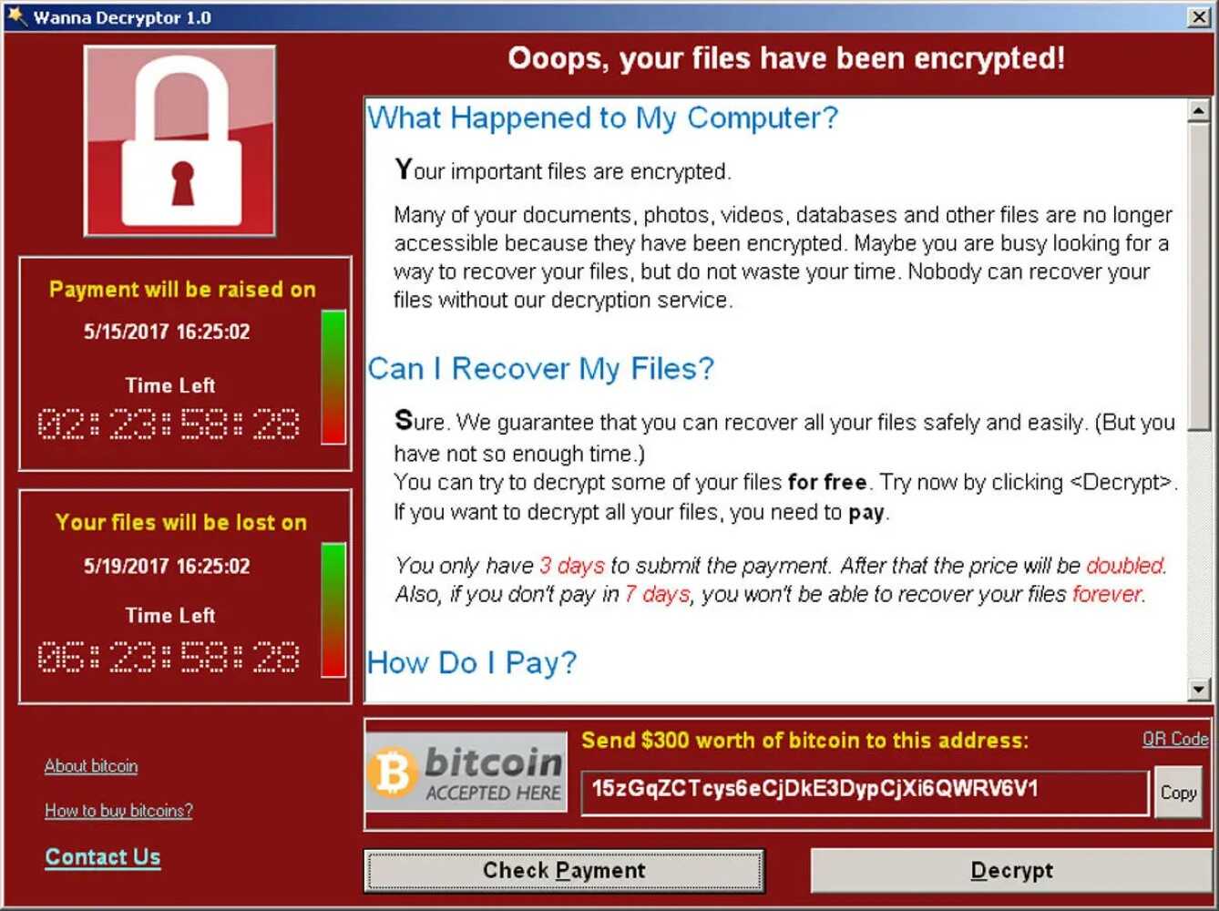 The WannaCry program, a Windows 2000 interface with a red background, a lock in the top left with two timers below and a scrollable window on what to do. A Bitcoin wallet address is at the bottom with two buttons, &quotCheck Payment&quot and "Decrypt&quot