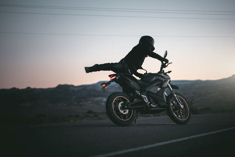 biker with coat flying up