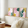mustard pink and green wall decor on side table
