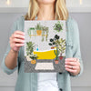 woman holding yellow bathroom print