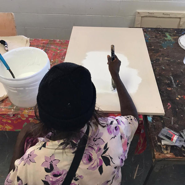 Julie Beasley preparing canvas for the Epenarra artists