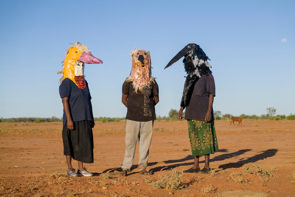 Rochelle Bonney, Lynette Bonney and Susie Peterson don masks built during Barkly Artists Camp 2022