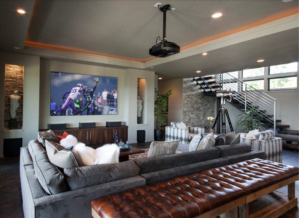 modern basement media room with projector screen and contemporary furniture