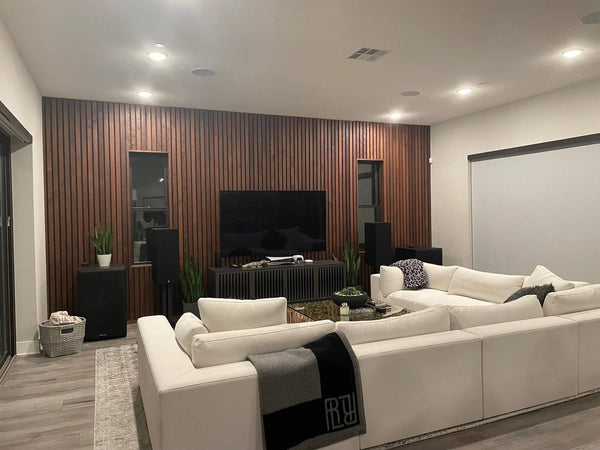 mid-century modern living room with vertical walnut wood slat wall panelling and large white sectional