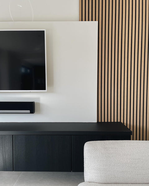 scandinavian living room with vertical wood slat wall panelling and white walls