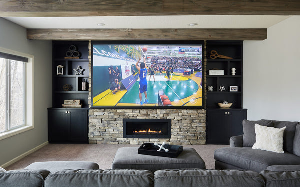 rustic living room with projector screen and a fireplace