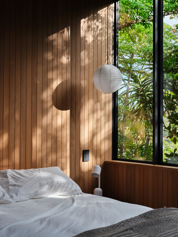 sunny-bedroom-with-wood-panelling-accent-wall