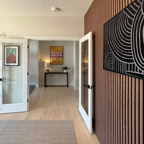 A modern hallway featuring wooden acoustic wall panels and minimalist decor, emphasizing the need for tips on how to clean acoustic wall panels.