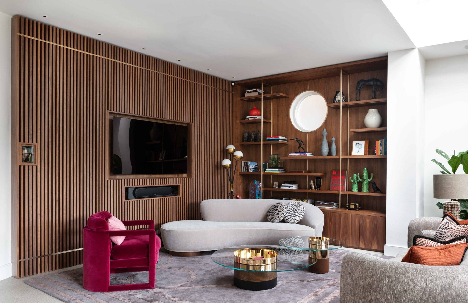 modern living room with built-in walnut shelving and a vertical wood slat accent wall