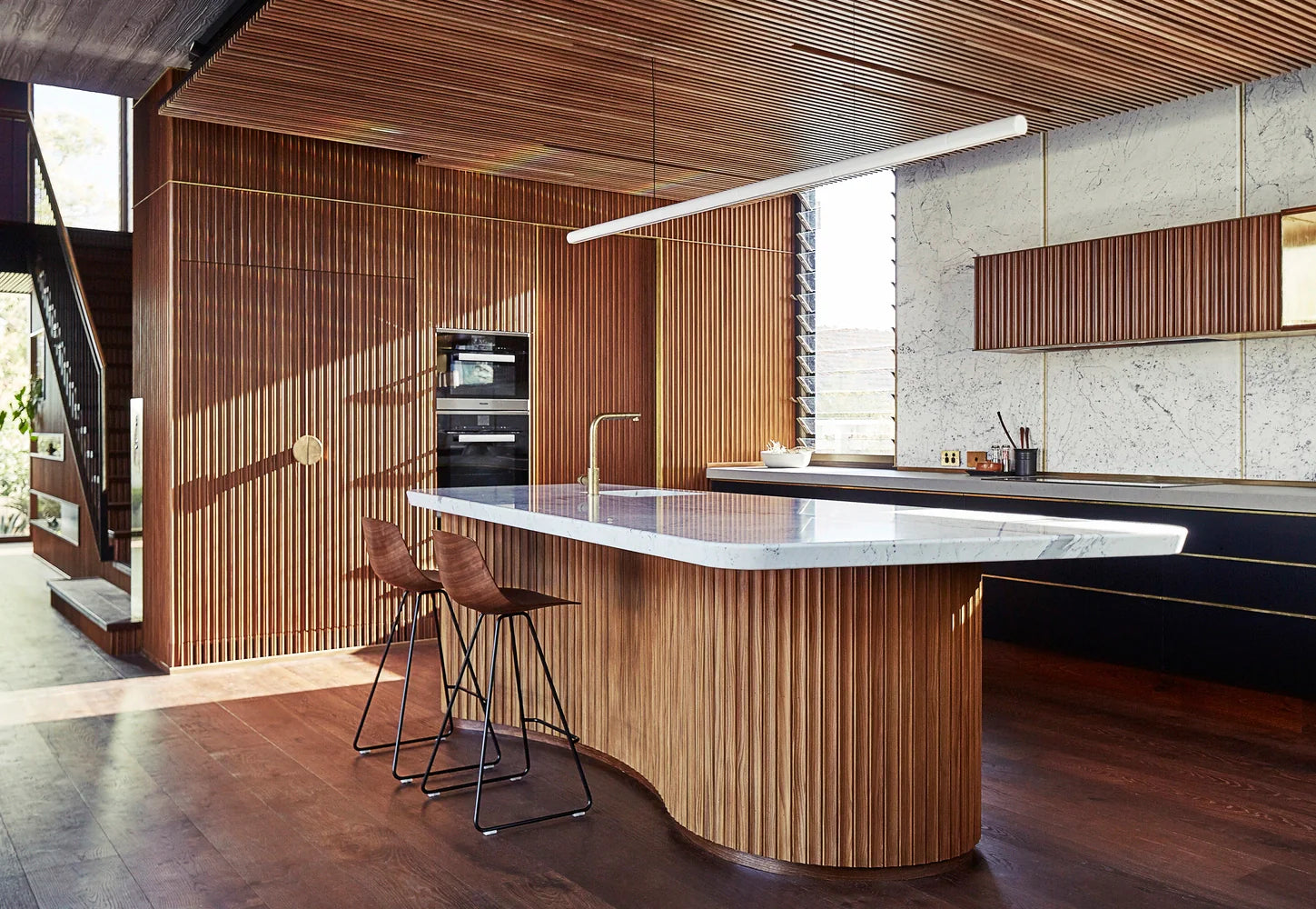 wood slat wall panels in a large kitchen