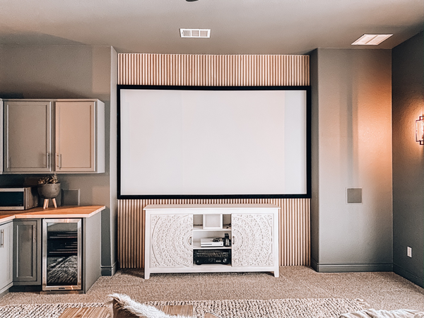 modern farmhouse home theater living room design with white oak wood slat feature wall