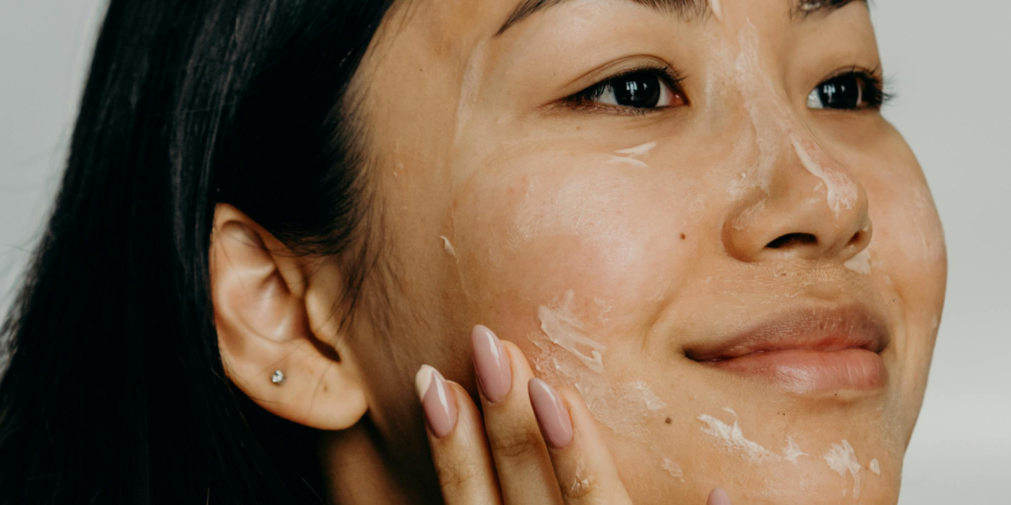 Woman applying moisturizer