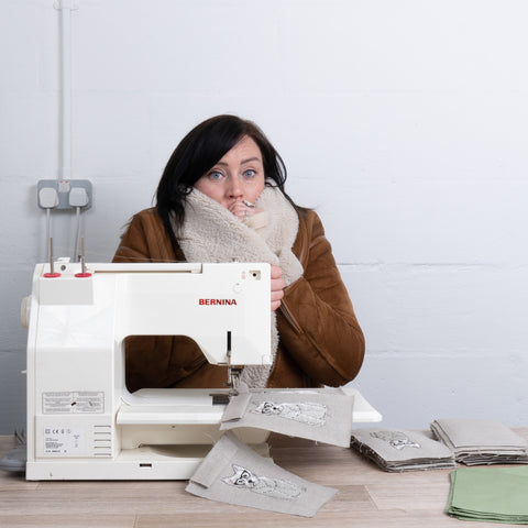 Kate Sproston sat behind her sewing machine and looking very cold