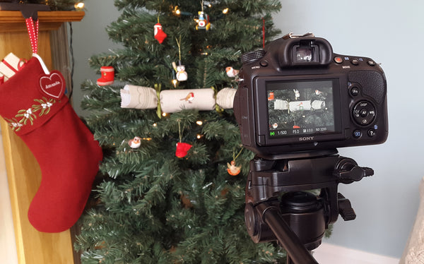 Camera recording Christmas stocking and cracker on a Christmas tree